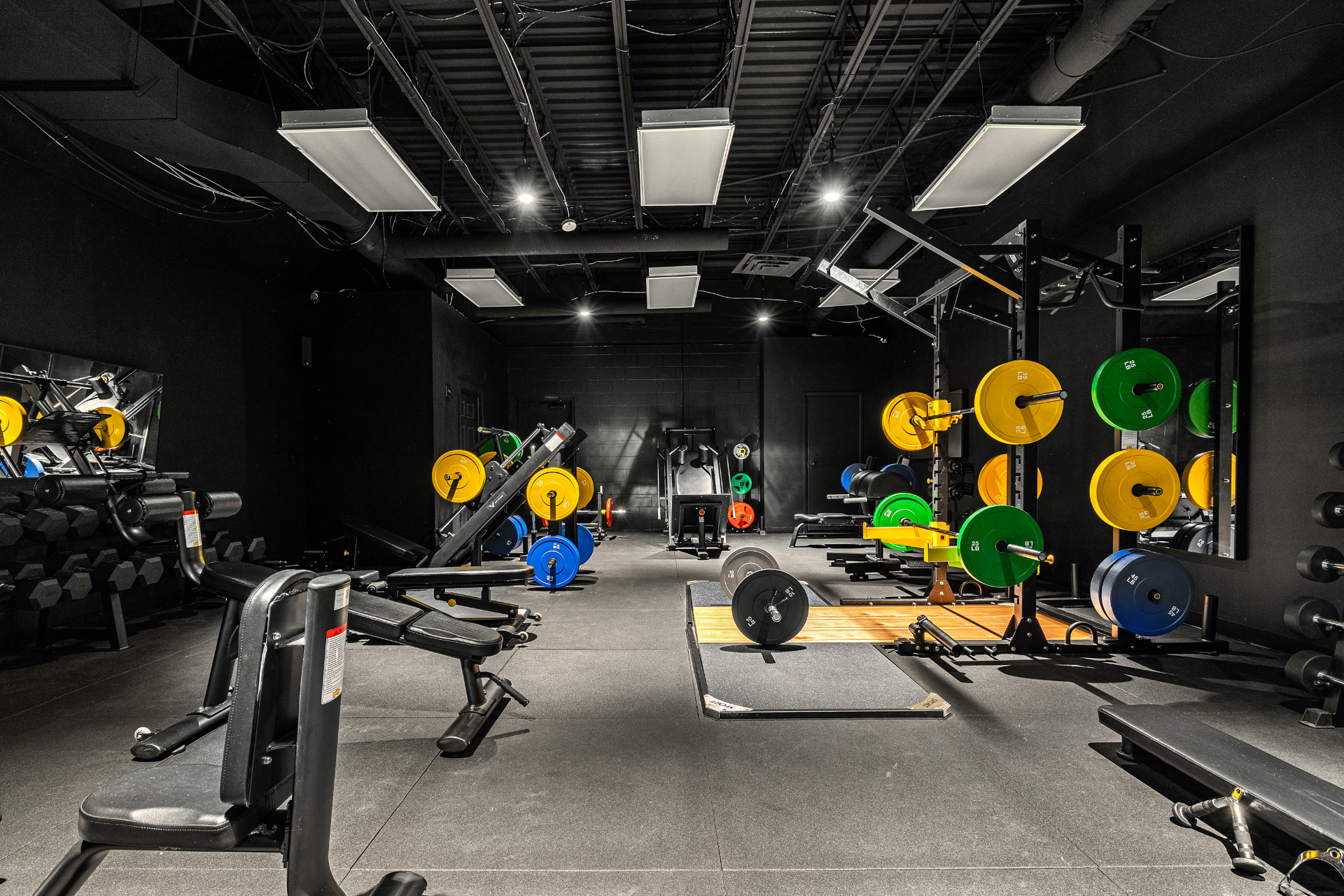 Free-weight room with platforms, racks, and incline benches